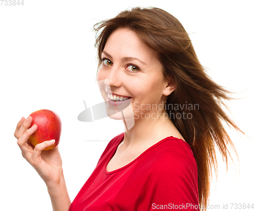 Image of Young happy girl with apple