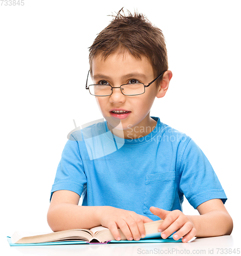 Image of Little boy is reading a book