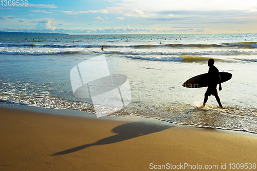 Image of Surfer walk out ocean silhouette