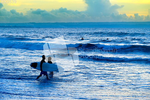 Image of Silhouette of surfers couple