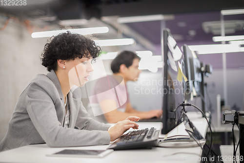 Image of female software developer using desktop computer