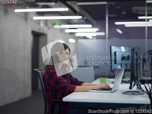 Image of female software developer using laptop computer