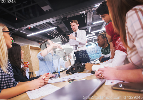 Image of multiethnic business team learning about drone technology