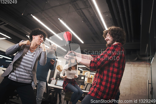 Image of multiethnics business team boxing at office