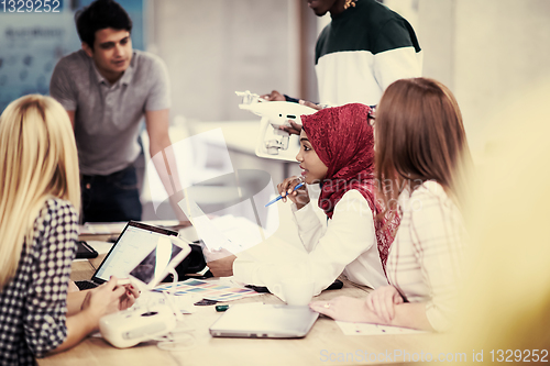 Image of multiethnic business team learning about drone technology