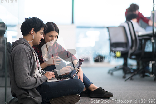 Image of software developers couple working on the floor