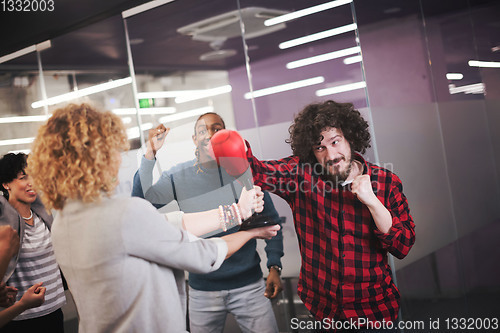 Image of multiethnics business team boxing at office