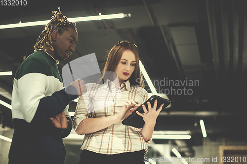 Image of multiethnic business couple using a tablet computer