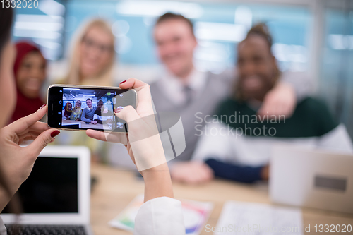 Image of businesswoman using mobile phone for taking photo