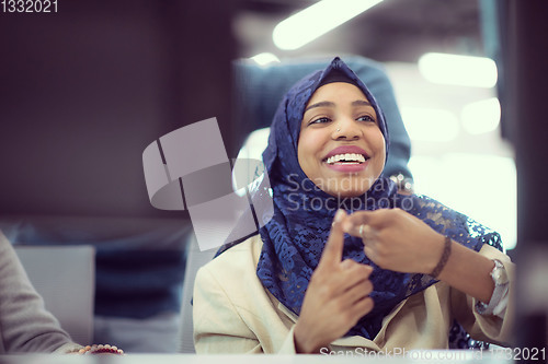 Image of black muslim female software developer at work