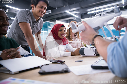 Image of multiethnic business team learning about drone technology