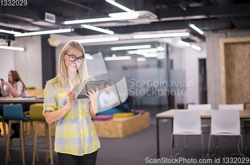 Image of blonde businesswoman working online using digital tablet