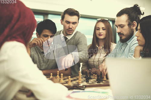 Image of multiethnic group of business people playing chess