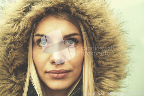 Image of portrait of young blonde girl wearing winter jacket