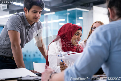 Image of multiethnic business team learning about drone technology