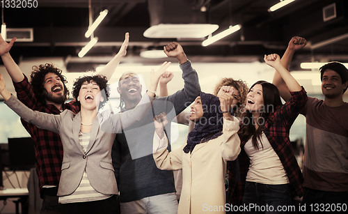 Image of portrait of young excited multiethnics business team