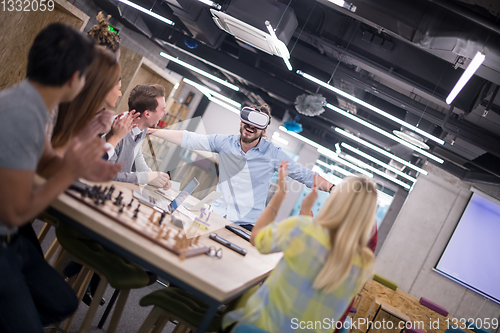 Image of Young Multiethnic Business team using virtual reality headset