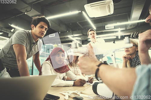 Image of multiethnic business team learning about drone technology