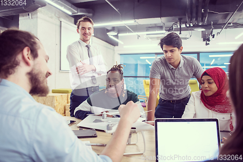 Image of multiethnic business team learning about drone technology