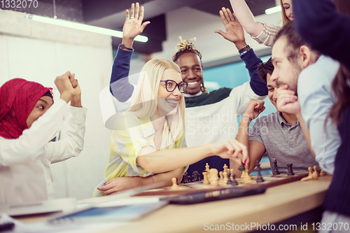 Image of multiethnic group of business people playing chess