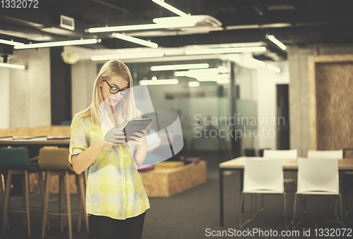 Image of blonde businesswoman working online using digital tablet