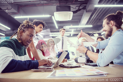 Image of multiethnic business team learning about drone technology