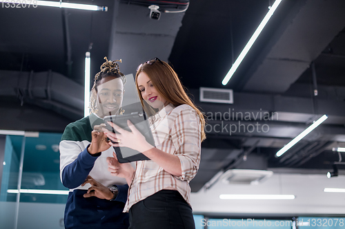 Image of multiethnic business couple using a tablet computer