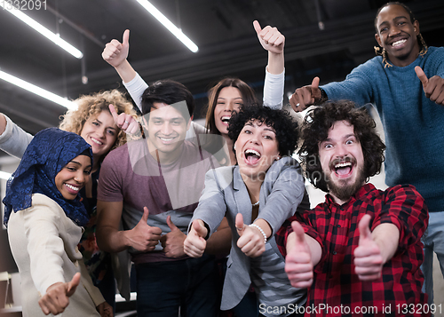 Image of portrait of young excited multiethnics business team