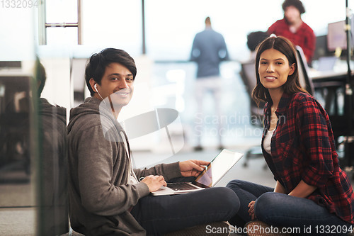 Image of software developers couple working on the floor