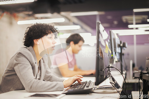 Image of female software developer using desktop computer