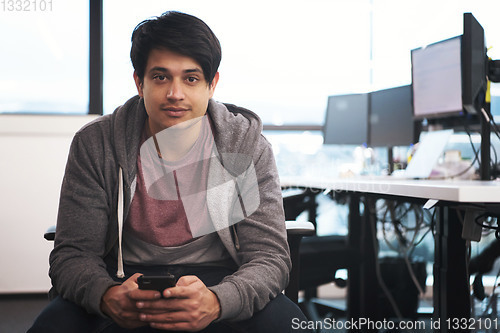 Image of software developer using mobile phone