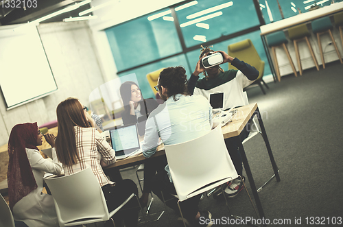 Image of Young Multiethnic Business team using virtual reality headset