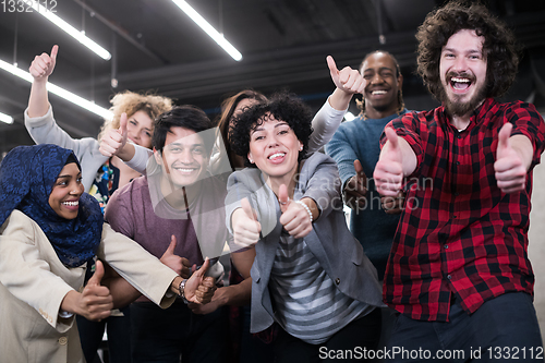 Image of portrait of young excited multiethnics business team