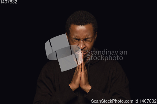 Image of Close up portrait of young man isolated on black studio background