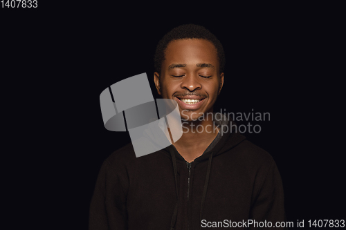 Image of Close up portrait of young man isolated on black studio background