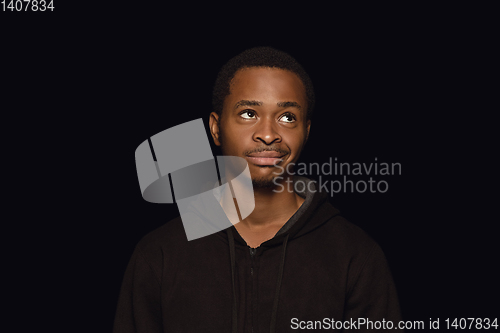 Image of Close up portrait of young man isolated on black studio background