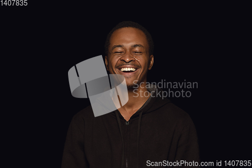 Image of Close up portrait of young man isolated on black studio background