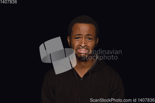 Image of Close up portrait of young man isolated on black studio background