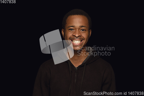 Image of Close up portrait of young man isolated on black studio background