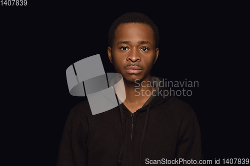 Image of Close up portrait of young man isolated on black studio background