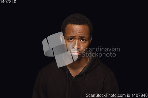 Image of Close up portrait of young man isolated on black studio background