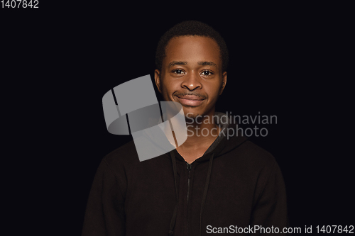 Image of Close up portrait of young man isolated on black studio background