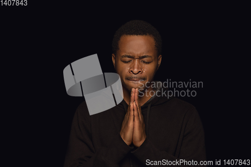 Image of Close up portrait of young man isolated on black studio background