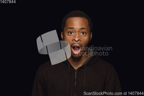 Image of Close up portrait of young man isolated on black studio background