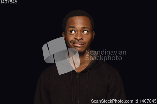 Image of Close up portrait of young man isolated on black studio background
