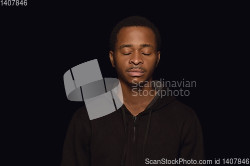 Image of Close up portrait of young man isolated on black studio background