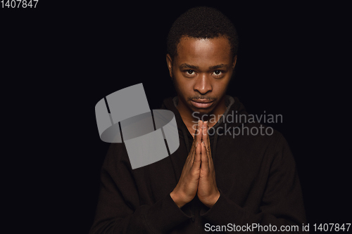 Image of Close up portrait of young man isolated on black studio background
