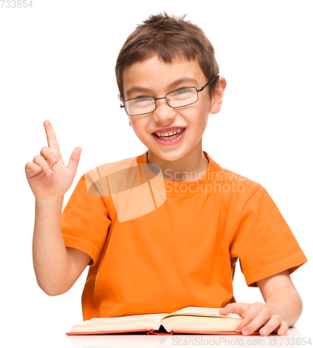 Image of Little boy is reading a book