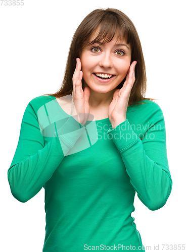 Image of Woman is holding her face in astonishment