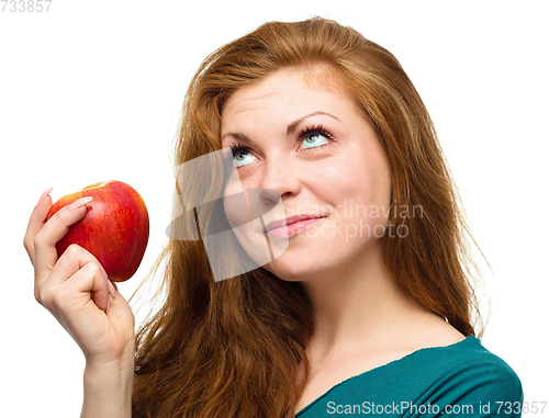 Image of Young happy girl with apple